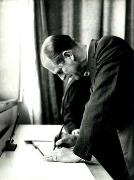 Duke of Edinburgh signing a register at the opening of the Tower and Extension Blocks